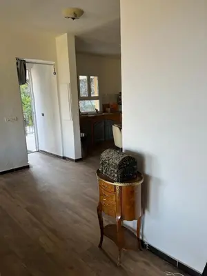 an empty living room with a table and a kitchen at Villa avec vue et piscine privée in Moltifao