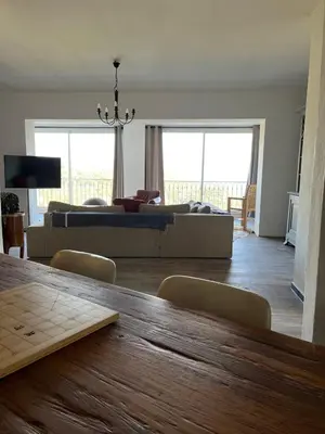 a living room with a couch and a table at Villa avec vue et piscine privée in Moltifao