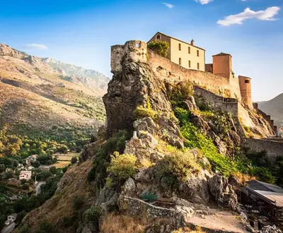 a castle on the side of a mountain at Charmant studio en centre-ville in Corte