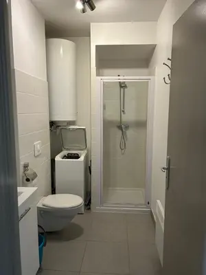 a bathroom with a toilet and a shower in it at Charmant studio en centre-ville in Corte