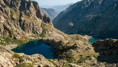 a view of a mountain valley with a blue lake at Charmant studio en centre-ville in Corte