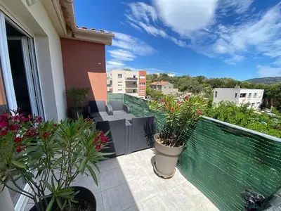 a balcony with potted plants on a building at Entire air-conditioned accommodation, Porto Vecchio center in Porto-Vecchio