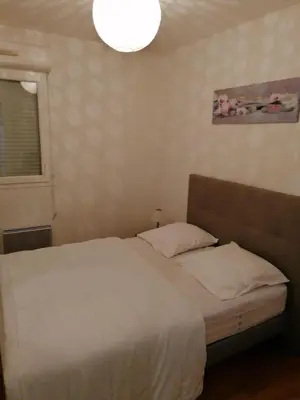 a bedroom with a white bed and a light at Entire air-conditioned accommodation, Porto Vecchio center in Porto-Vecchio
