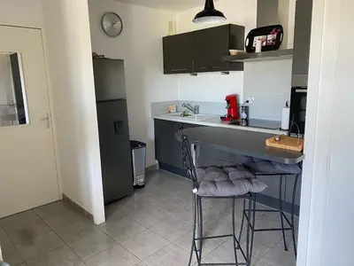 a kitchen with a counter and a sink and a refrigerator at Entire air-conditioned accommodation, Porto Vecchio center in Porto-Vecchio