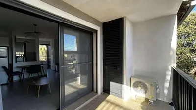 a house with a large sliding glass door with a dining room at Location appartement 6 pers les marines de Bravone in Linguizzetta