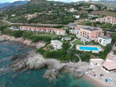 an aerial view of a resort next to the water at Appartement les pieds dans l'eau in Calcatoggio
