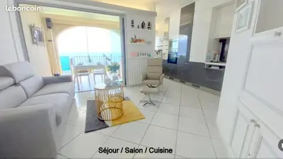 a living room with a couch and a table at Appartement les pieds dans l'eau in Calcatoggio