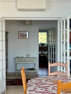 a dining room with a table and a desk at Vista di Nata appartement en ville entre mer et maquis in Ajaccio