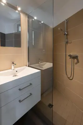 a bathroom with a shower and a sink and a mirror at Villa SOPRA - Sea View & Pool - Porto-Vecchio in Porto-Vecchio