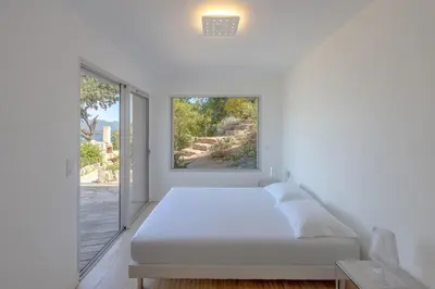 a white bedroom with a bed and a window at Villa SOPRA - Sea View & Pool - Porto-Vecchio in Porto-Vecchio