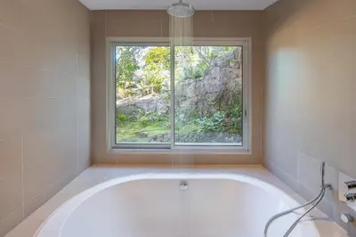 a bath tub in a bathroom with a window at Villa SOPRA - Sea View & Pool - Porto-Vecchio in Porto-Vecchio