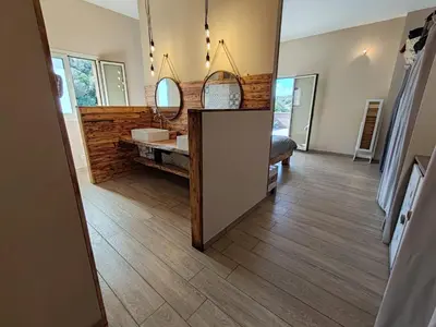 a bathroom with a sink and a mirror at Villa KECA in Bonifacio