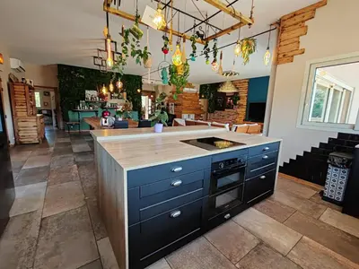 a kitchen with a blue island with a counter top at Villa KECA in Bonifacio