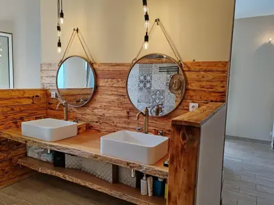 a bathroom with two sinks and two mirrors at Villa KECA in Bonifacio