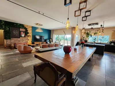 a living room with a wooden table and a couch at Villa KECA in Bonifacio