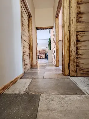 an empty hallway with wooden doors in a house at Villa KECA in Bonifacio