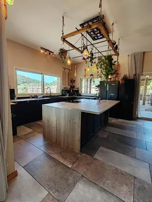 a large kitchen with a large island in the middle at Villa KECA in Bonifacio