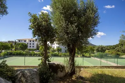 two trees in front of a tennis court at Domaine d'Arca - Hugo 01 - 5 personnes in Porto-Vecchio