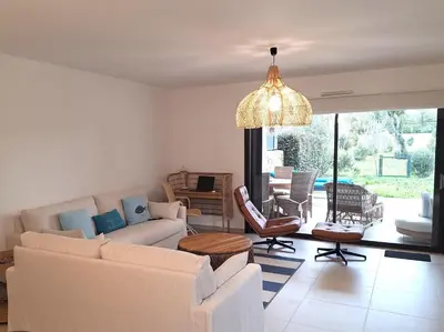 a living room with a couch and chairs and a chandelier at Domaine d'Arca - Hugo 01 - 5 personnes in Porto-Vecchio
