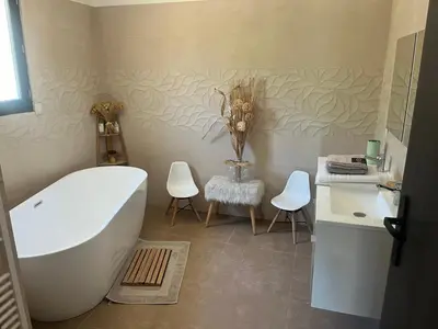 a living room with a couch and a table at Villa moderne piscine vue mer in Ajaccio