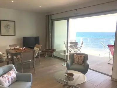 a living room with a view of the ocean at Appartement vue mer Piscine Solenzara Résidence Mare Festa B132 in Kamiesch