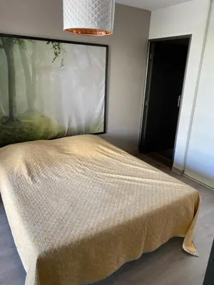 a bed in a room with a large window at Tosca opéra in Ajaccio