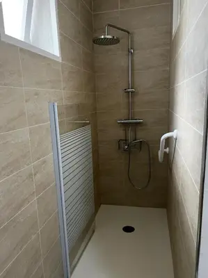 a bathroom with a shower with a shower head at Chez MANI in Eccica-Suarella