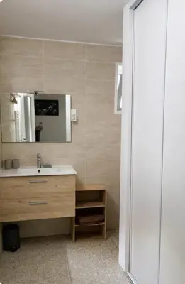 a bathroom with a sink and a mirror at Chez MANI in Eccica-Suarella