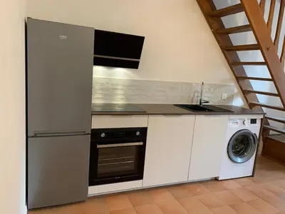 a kitchen with a sink and a washing machine at Maison de village typique en Corse mer montagne