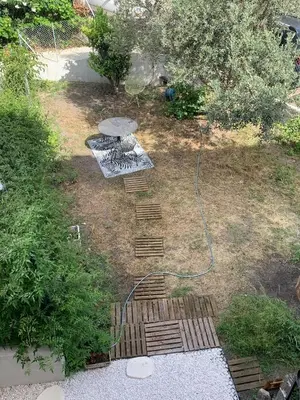 a garden with some stairs in the grass at Maison de village typique en Corse mer montagne