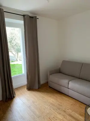 a living room with a couch and a window at Maison de village typique en Corse mer montagne