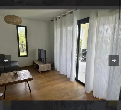 a living room with white curtains and a television at Villa Mado 4 Bedrooms, Pool, 6 Personnes, Ste Lucie de Porto Vecchio in Zonza