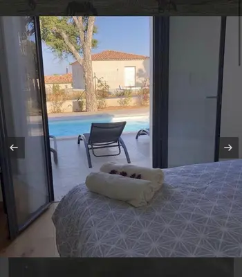 a bedroom with a bed and a view of a pool at Villa Mado 4 Bedrooms, Pool, 6 Personnes, Ste Lucie de Porto Vecchio in Zonza