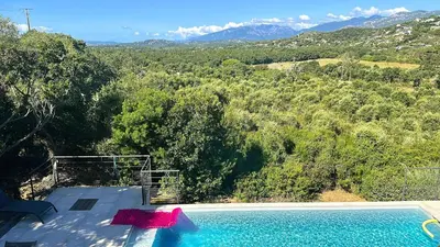 a swimming pool with a view of a mountain at Villa Casalonga, 8 pers, piscine chauffée, 1km plage in Cirendinu