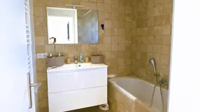 a bathroom with a sink and a tub and a mirror at Villa Casalonga, 8 pers, piscine chauffée, 1km plage in Cirendinu