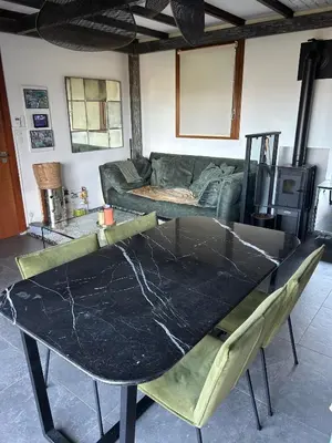 a glass table in a living room with a couch at Villa avec piscine et vue sur la baie d'Ajaccio in Ajaccio