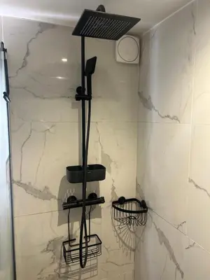 a bathroom with a marble wall with a hair dryer at Villa avec piscine et vue sur la baie d'Ajaccio in Ajaccio