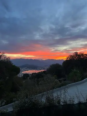 a sunset with a view of a city at Villa avec piscine et vue sur la baie d'Ajaccio in Ajaccio