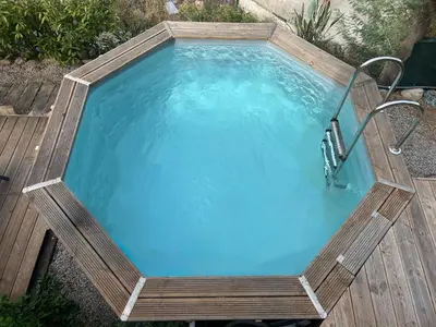 a swimming pool with a chair in it at Villa avec piscine et vue sur la baie d'Ajaccio in Ajaccio