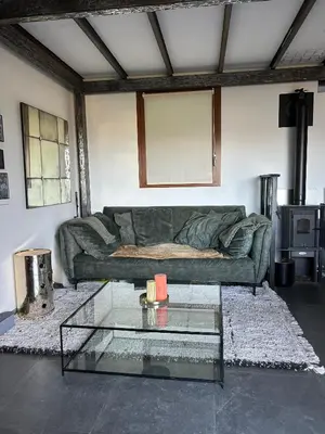 a living room with a couch and a glass table at Villa avec piscine et vue sur la baie d'Ajaccio in Ajaccio