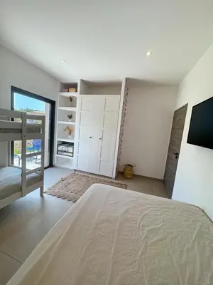 a bedroom with a bed and a tv in it at Casa Cagna, 3 bedrooms, Heated pool, 8people in Figari