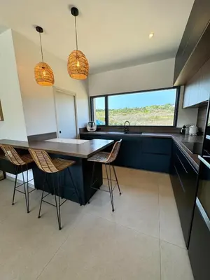 a kitchen with a table and chairs in a room at Casa Cagna, 3 bedrooms, Heated pool, 8people in Figari