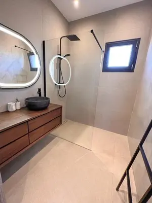 a bathroom with a sink and a shower with a mirror at Casa Cagna, 3 bedrooms, Heated pool, 8people in Figari