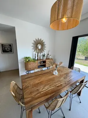 a dining room with a wooden table and chairs at Casa Cagna, 3 bedrooms, Heated pool, 8people in Figari