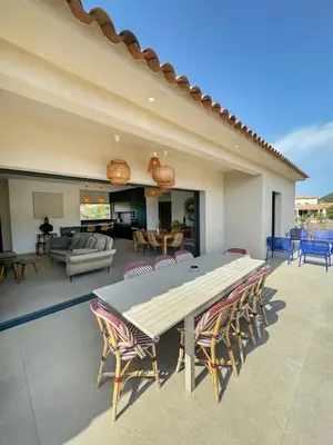 a large patio with a table and chairs at Casa Cagna, 3 bedrooms, Heated pool, 8people in Figari