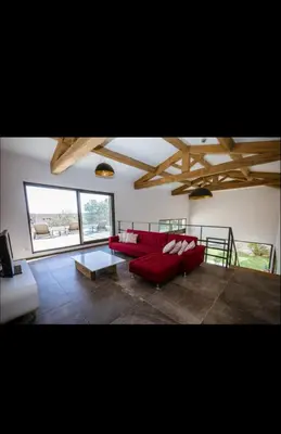 a living room with a red couch and a table at Villa L'Orangerie, 4 Bedrooms, 8 People, pool, Lecci in Lecci