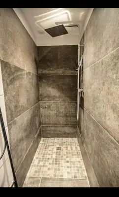 a bathroom with a shower with a tiled floor at Villa L'Orangerie, 4 Bedrooms, 8 People, pool, Lecci in Lecci