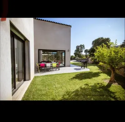 a house with a patio and a yard with grass at Villa L'Orangerie, 4 Bedrooms, 8 People, pool, Lecci in Lecci