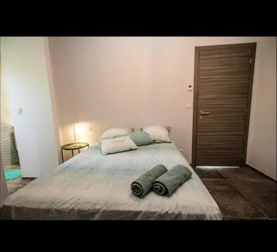 a bedroom with a bed with two pillows on it at Villa L'Orangerie, 4 Bedrooms, 8 People, pool, Lecci in Lecci