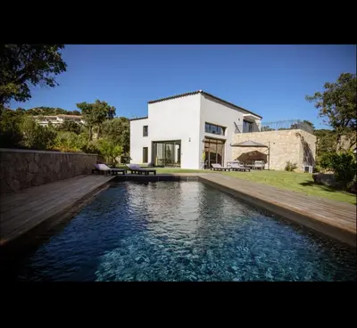 a house with a swimming pool in front of a house at Villa l'orangerie, 2 chambres , Piscine, 4personnes in Lecci